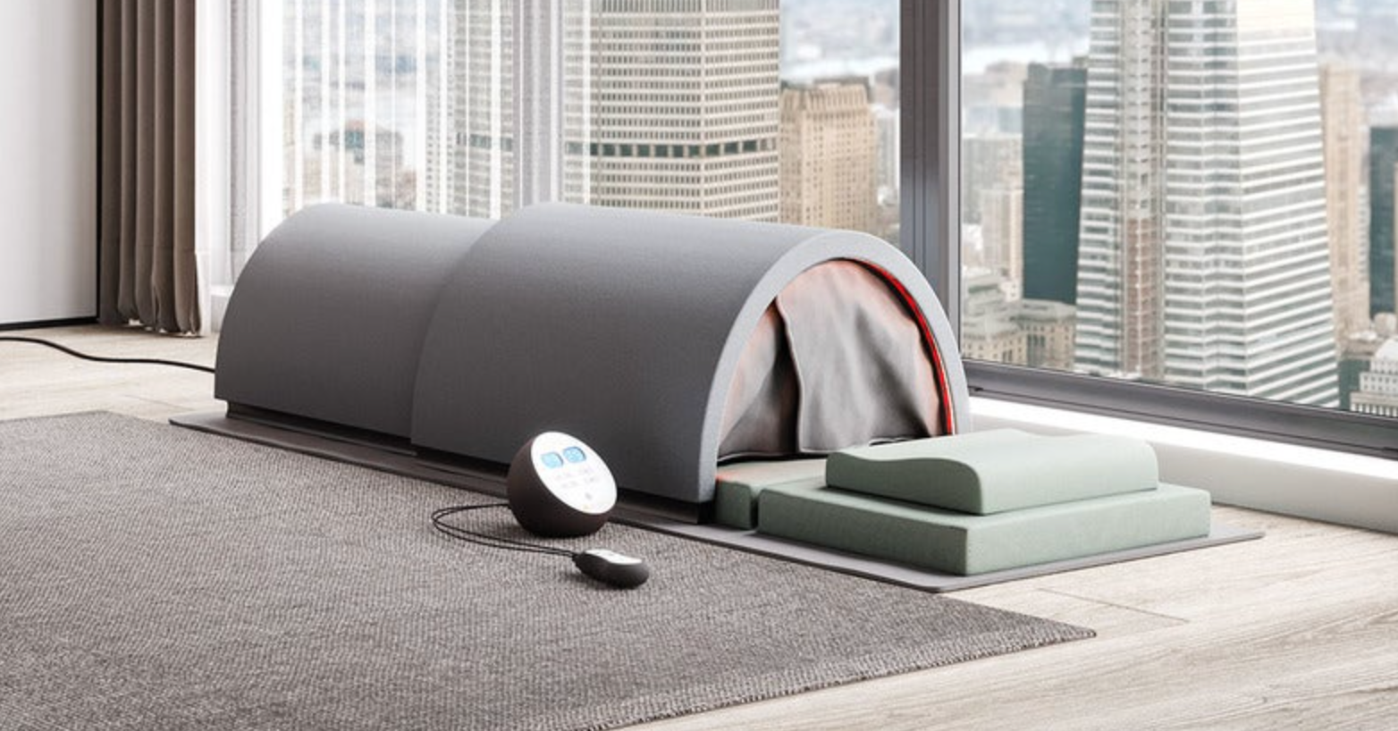 Sunlighten portable infrared sauna shown fully assembled near a window that overlooks a scenic skyline.